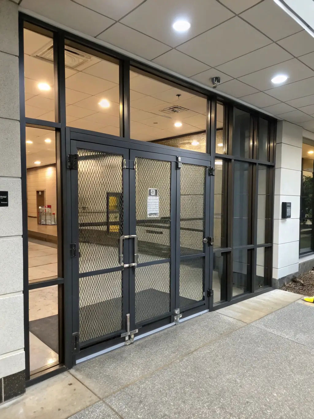 A modern office entrance featuring a sleek stainless steel and glass gate, exemplifying our ability to create welcoming and stylish commercial spaces.